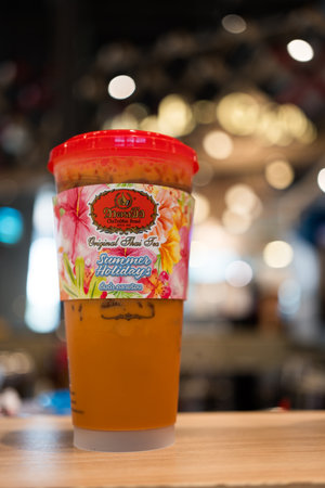 Samut Prakan, Thailand - April 29, 2023 : A Glass of iced Thai tea, tea by Cha Tra Mue, the popular Thai tea brandのeditorial素材