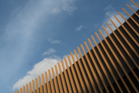 Image of the modern wood roof contrasting with the clear blue sky. Suitable for use as a beautiful background image.の写真素材