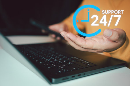 Nonstop service concept. Businessman hand holding virtual 24-7 with clock on hand for worldwide nonstop and full-time available contact of service concept. 24 hours a day and 7 days a week.の写真素材