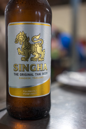 Bangkok, Thailand - June 23, 2024 : A bottle Singha beer put on the dinner table in the restaurantのeditorial素材