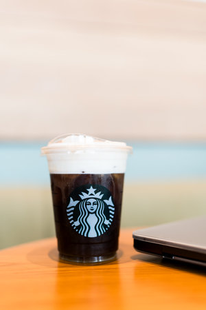 Bangkok, Thailand - June 24, 2024 : Starbucks cold brew beverage cup on wood table at Starbucks shopのeditorial素材