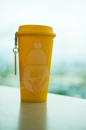 Bangkok, Thailand - June 25, 2024 : A red yellow reusable cup from Cafe Amazon, Get power to enhance your luck with cup name of Dragon pattern. Get 1 free Dragon Reusable Cup in June 25, 2024のeditorial素材