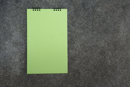 Green blank desktop calendar on cement background, flat lay for your text, copy spaceの写真素材