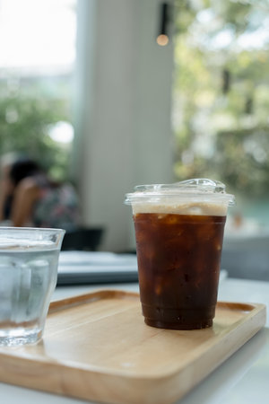 A Nitro cold brew coffee served on wood tray in cafe shop.