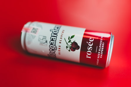 Samut Prakan, Thailand - June 28, 2024 : Belgian Hoegaarden Rosee fruit beer 330 ml size. on a red backgroundのeditorial素材