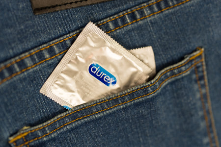 Samut Prakan, Thailand - June 30, 2024 : Durex condom in the pocket of blue jeans. A concept of prevention.のeditorial素材