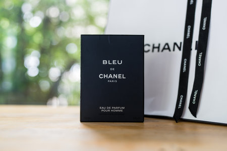 Bangkok, Thailand - July 1, 2024 : A box of Bleu De Chanel, luxury perfume for men on wood table
