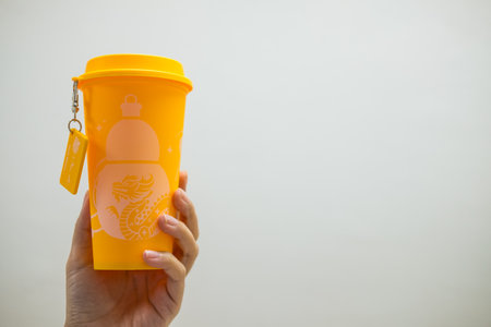 Bangkok, Thailand - June 25, 2024 : A red yellow reusable cup from Cafe Amazon, Get power to enhance your luck with cup name of Dragon pattern. Get 1 free Dragon Reusable Cup in June 25, 2024のeditorial素材