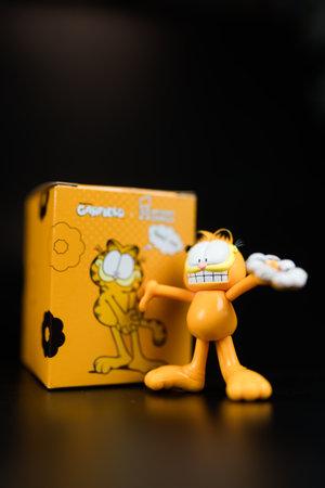 Bangkok, Thailand - July 15, 2024 : Mister Donut x Garfield. A cut toy of Garfield art toy collection, a popular cartoon.のeditorial素材
