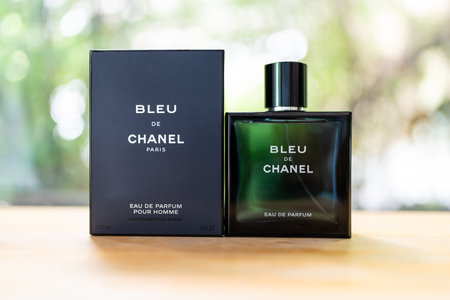 Bangkok, Thailand - July 15, 2024 : Bottles of perfume for men Bleu de Chanel placed on wood table against nature backgroundのeditorial素材