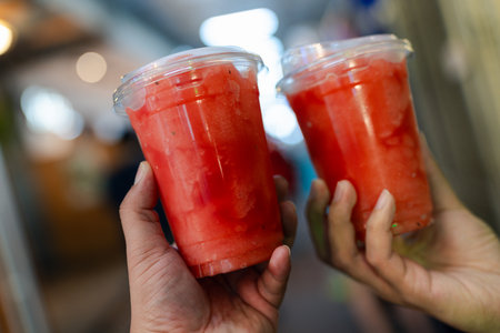 Two  plastic cup of watermelon smoothie. Close up