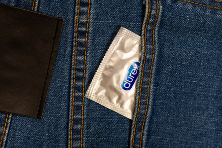 Samut Prakan, Thailand - July 19, 2024 : Condom Durex invisible in the front pocket of blue jeans. Healthy and safe sex.のeditorial素材