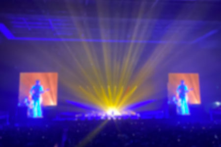 Disfocused concert stage with laser lights and beams. Stage lighting at the concert. Out focus concert lighting as backgroundの写真素材