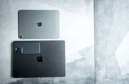 Bangkok, Thailand - August 3, 2024 : Apple brand devices iPhone 15 pro, iPad air and Macbook Pro on stone background, created by Apple Inc.のeditorial素材