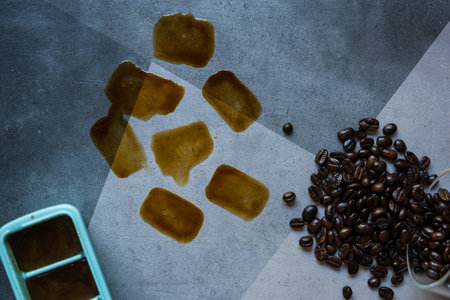 Coffee stains on the ground from ice cubes and coffee beansの写真素材