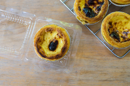 baked egg tart dessert put in box on wood table