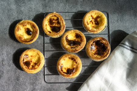 Homemade fresh egg tart dessert freshly baked and cooling on rackの写真素材
