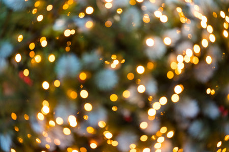 Defocused orange lights background. Festive lights as symbol of coming Christmas and New Year. Backdrop for your designの写真素材