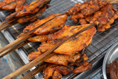 Grilled skewers chicken on the tray. Traders at the beach in Thailand. Very popular foods in Thailand.の写真素材