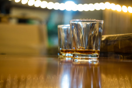 Vodka in shot glasses on the table with a bokeh background.の写真素材