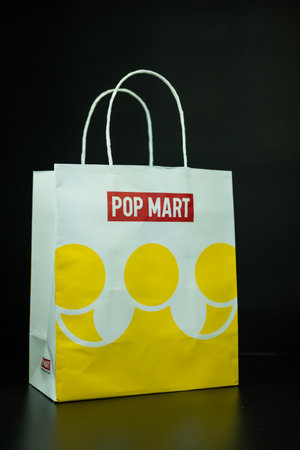 Bangkok, Thailand - September 21, 2024 : White paper shopping bag with white handle from POP MART. POP MART is the largest and fastest growing pop-toy maker in China.のeditorial素材
