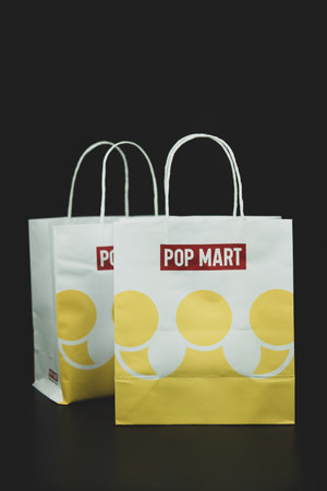 Bangkok, Thailand - September 21, 2024 : White paper shopping bag with white handle from POP MART. POP MART is the largest and fastest growing pop-toy maker in China.のeditorial素材