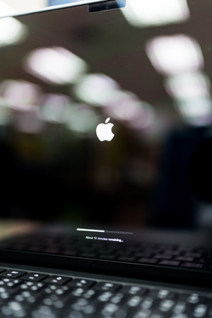 Bangkok, Thailand - September 21, 2024 : iOs loading installing Software update About ten minutes left sign on the black screen of Apple MacBook Pro laptop computerのeditorial素材