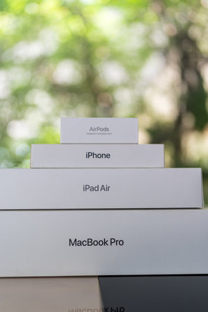 Bangkok, Thailand - September 21, 2024 : Apple products boxes like a pyramid include Macbook Pro, iPad Air, iPhone, and AirPods against nature backgroundのeditorial素材