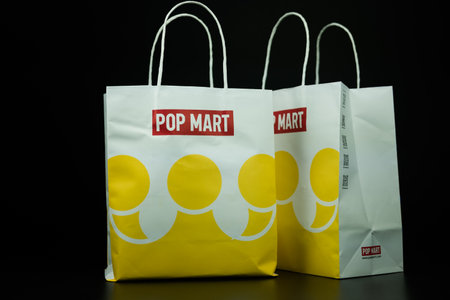 Bangkok, Thailand - September 25, 2024 : White paper shopping bag with white handle from POP MART. POP MART is the largest and fastest growing pop-toy maker in China.のeditorial素材
