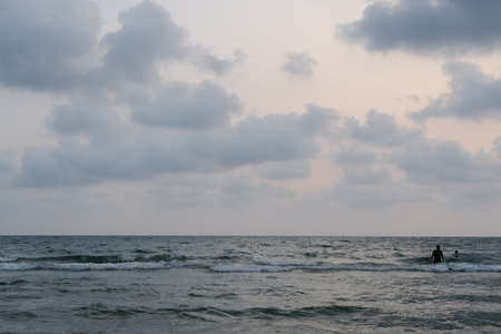 Sand beach and wave water in sea ocean at sunset dusk time for Thai people and foreign travelers travel visit and rest relax play swimming at Chanthaburi, Thailandの写真素材