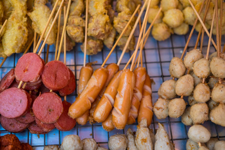 Snack of Thai, various fried skewers meatball and fried skewers sausage at Thai street food.の写真素材