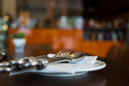 Selective focus  fork and spoon lies on a paper napkin at cafeの写真素材