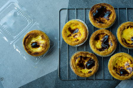 A delicious egg tart is the perfect sweet dessert placed on a grille, delicious bakery and dessert...