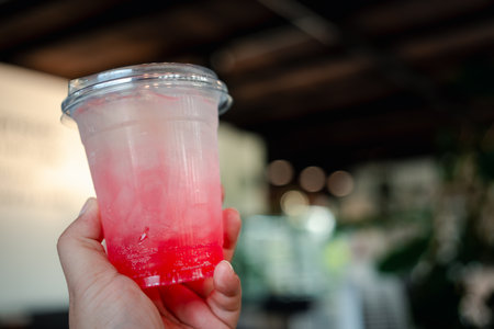 Strawberry Italian soda with ice on handの写真素材
