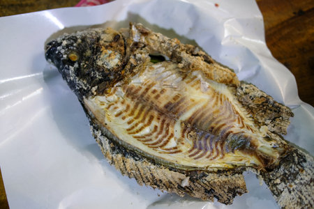 Selective focus on grilled Tilapia fish that covered with salt grill. Concept healthy food. Thai cooking style.の写真素材