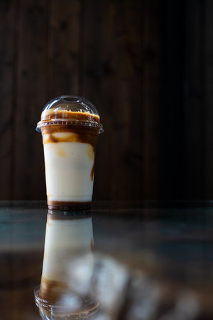 A cup of fresh and delicious ice blended coconut coffee in the cafeの写真素材