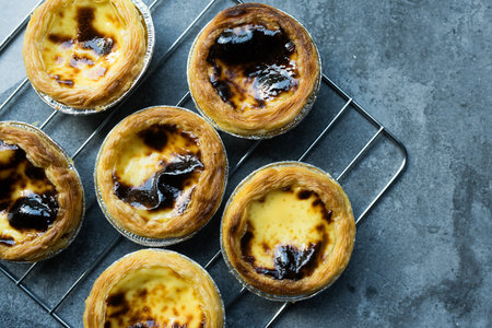 Delicious freshly baked egg tart dessert served on rackの写真素材