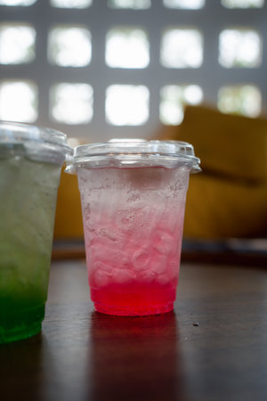 Strawberry Italian soda with ice on wood tableの写真素材
