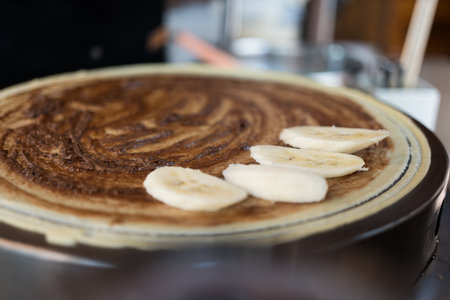 Crepes cakes, banana and chocolate for Thailand road snack. Small business, entrepreneur and crepe for nutrition, eating and sweet cuisine in asian stall or cartの写真素材