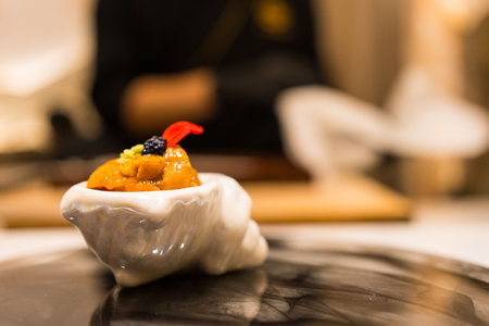 Luxury Japanese sea urchin in white mini bowl. Omakase Japanese foodの写真素材