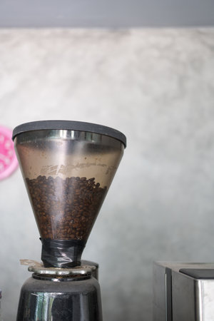 Coffee beans in coffee grinder machine at cafeの写真素材