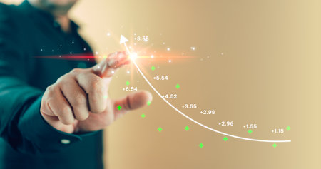 Man touch on the screen with stock graph is reaching its peak Interest rate up, calculating income and return. Interest rate and dividend concept.の写真素材