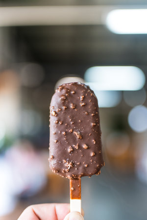 Chocolate ice cream bar with crushed peanut nuts, pastry and sweet food style concept