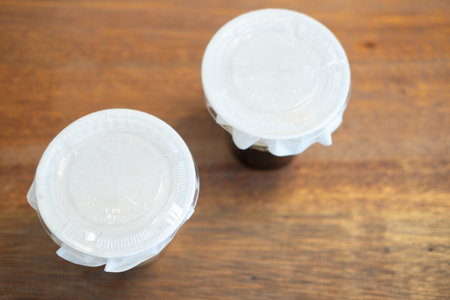 Top view of two take away of glass with paper cover glass on wood table. The concept of take away...
