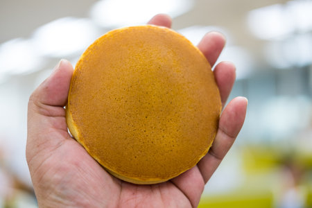 Man holding dorayaki. Dorayaki Is a pancake in Japan.の写真素材