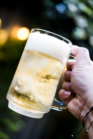 Cold beer with foam in a mug, fresh cold beerの写真素材