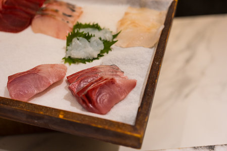 Close up of fresh set of raw sashimi fish on wooden board backgroundの写真素材
