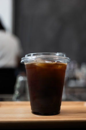 Close up of iced americano coffee with ice cubes in a takeaway glassの写真素材