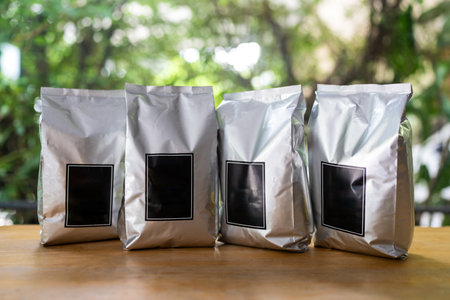 A row of packaging with empty blank black labels for coffee beanの写真素材