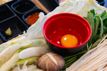 Raw egg served with lunch meal as sauce of sukiyaki, hygienic egg safe to eat rawの写真素材